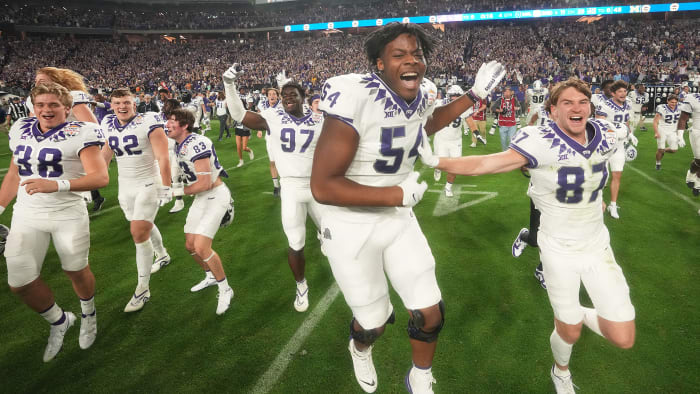 TCU players celebrate after beating Michigan